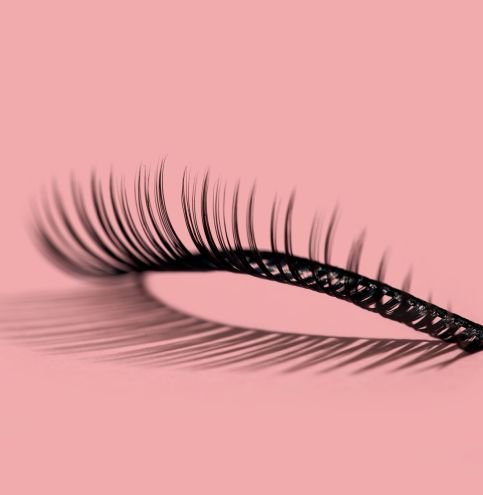 A pattern of false lashes on pink A pattern of separate false lashes on pink background with hard light makes shadow